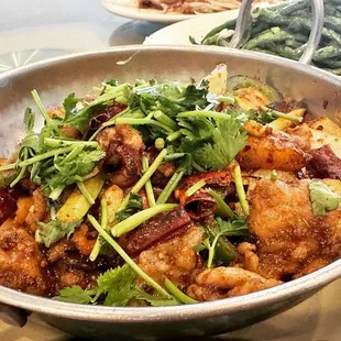 a bowl of stir fried chicken and vegetables