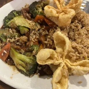 a plate of food with rice, broccoli, and other vegetables