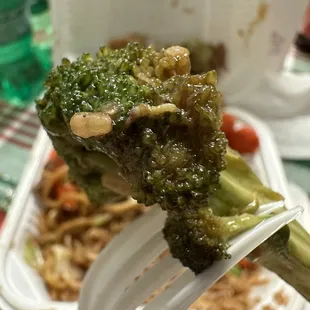  a piece of broccoli on a fork
