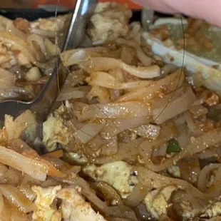a person cutting onions with a pair of tongs
