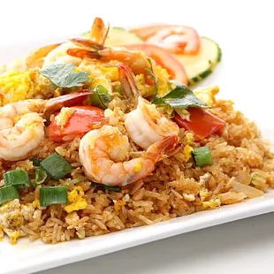 a plate of fried rice with shrimp and vegetables