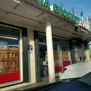 Unassuming tiny grocery with table service for 2-4 people in back