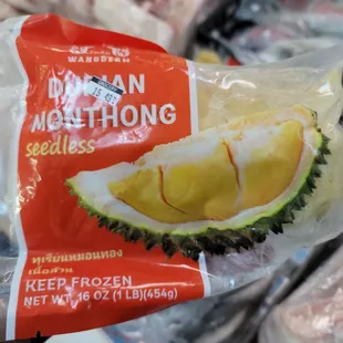a hand holding a bag of frozen fruit