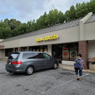 a woman walking in front of the store