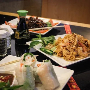 plates of food on a table with chopsticks
