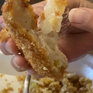 a person holding a half eaten pastry