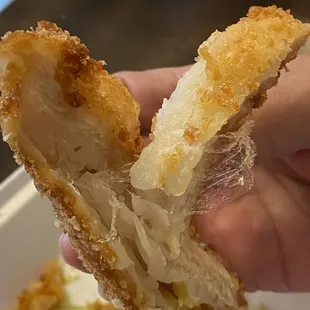 a hand holding a half eaten pastry