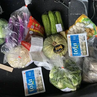 a variety of vegetables in plastic bags