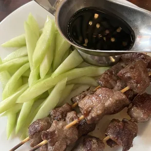 Beef skewers with cucumbers and barbecue sauce