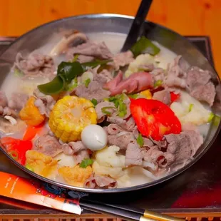 a bowl of food on a scale with chopsticks