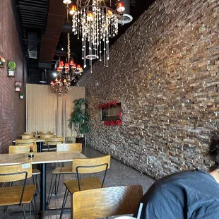 a woman sitting at a table in a restaurant