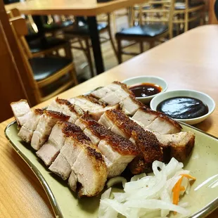 Roast Pork Belly with pickled carrots.