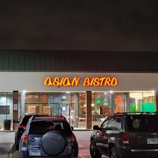 cars parked in front of a restaurant