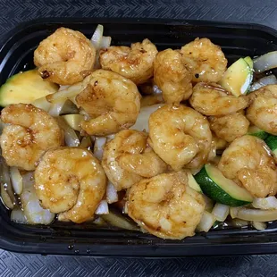 shrimp and vegetables in a black container