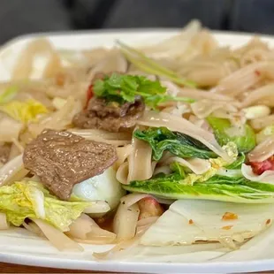 a plate of food with chopsticks