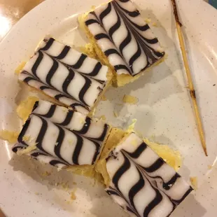 a plate of desserts with a toothpick