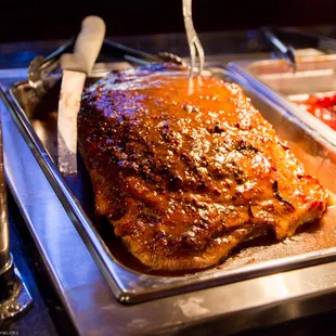 a large roast pork on a serving tray