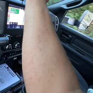 a man driving a car with a cell phone in his hand