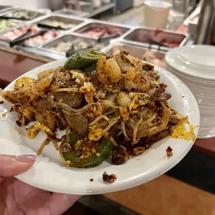 a person holding a plate of food