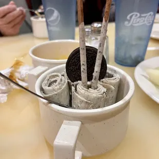 a cup of ice cream with a cookie in it