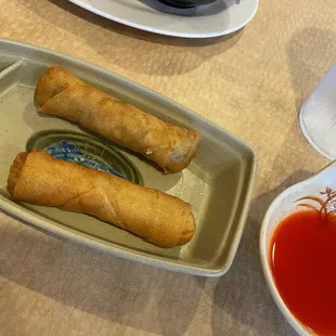Egg rolls in a cute little boat and sweet and sour sauce