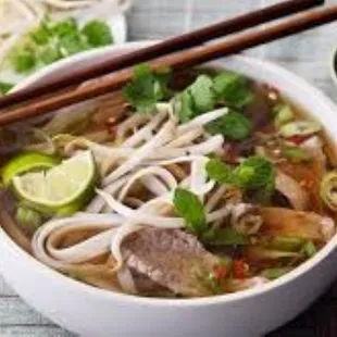 Vietnamese Pho (Beef Noodle soup with bean sprouts, basil, lime wedge and rice noodles)