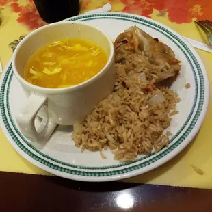 a bowl of soup, rice, and chicken