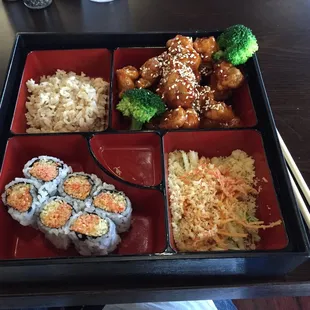 Brown rice, sesame chicken, spicy crab rolls and crab salad