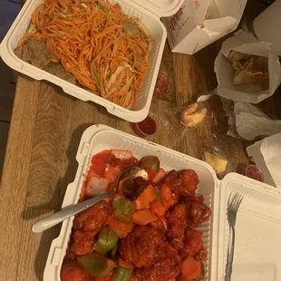 two take out containers of food on a table