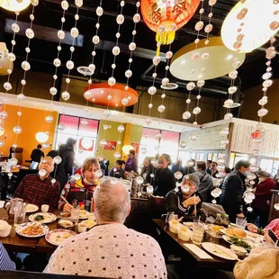 a large group of people eating at a restaurant