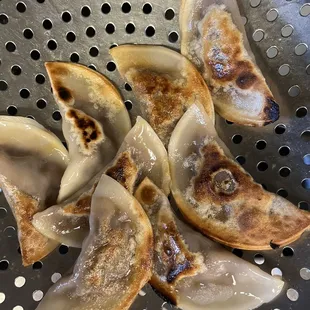 a pile of dumplings in a strainer