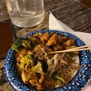 a plate of noodles, broccoli, and chicken