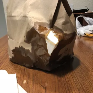 a brown paper bag on a wooden table