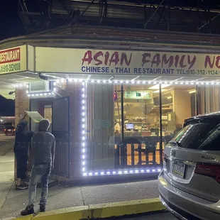 a man standing in front of a restaurant