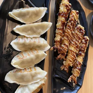 a plate of dumplings and a plate of meat