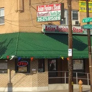 a restaurant with a green awning
