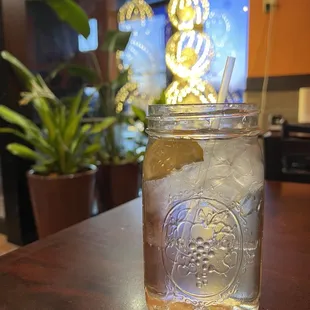 a mason jar filled with ice and lemon