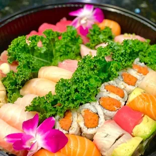 a bowl of sushi and vegetables