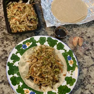 a plate of noodles and chicken