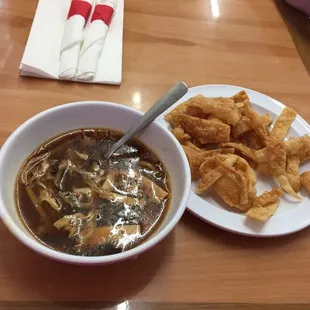 a bowl of soup and chips on a table