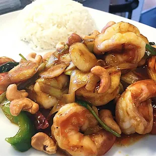 a plate of stir fried shrimp and vegetables