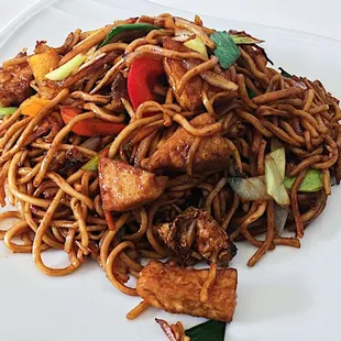 a plate of noodles with meat and vegetables