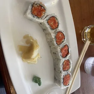 a plate of sushi and chopsticks