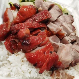 a take out container with rice and meat