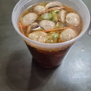 soup in a plastic cup on a table
