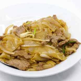 a plate of noodles and meat