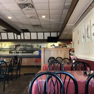 a dining area with tables and chairs