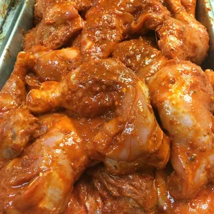 a pan of chicken wings with sauce