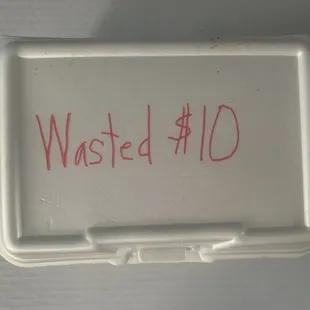 a white container with a red writing on it