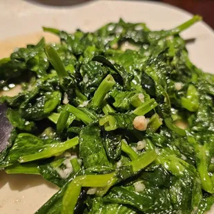 a plate of spinach with a spoon